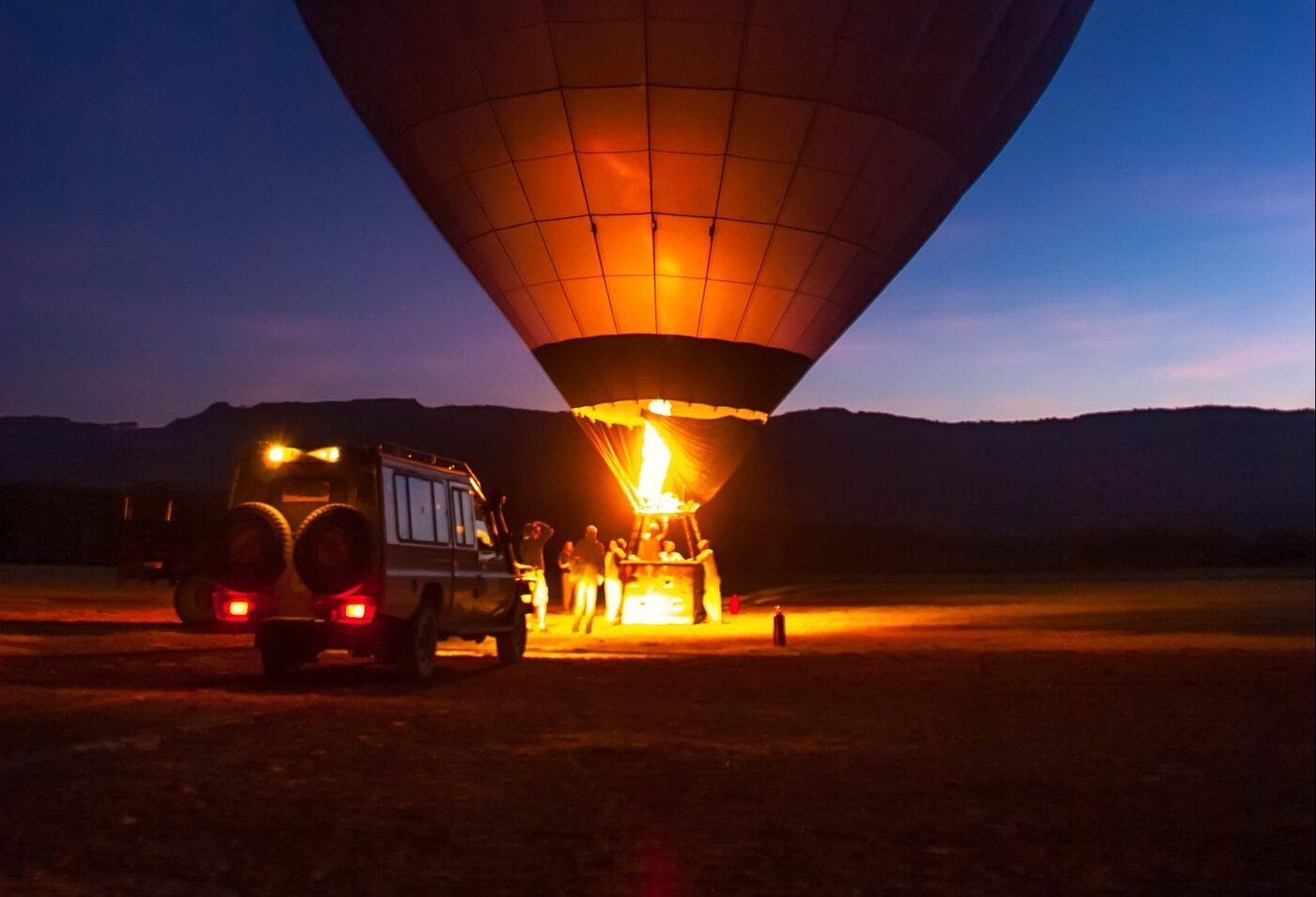 Hot air balloon being prepared at dawn in the Maasai Mara