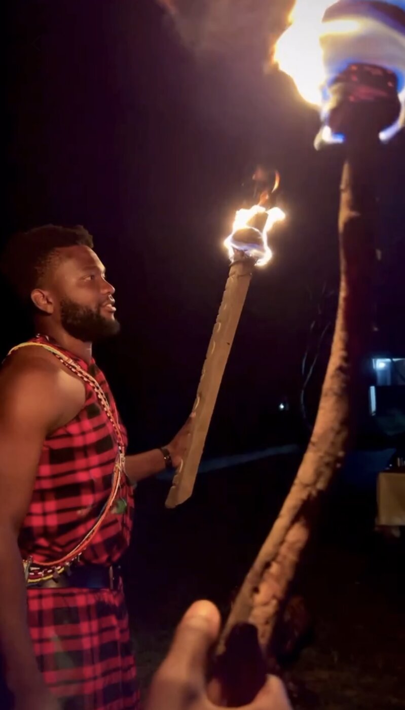 Maasai guide with fire torch — traditional storytelling evening